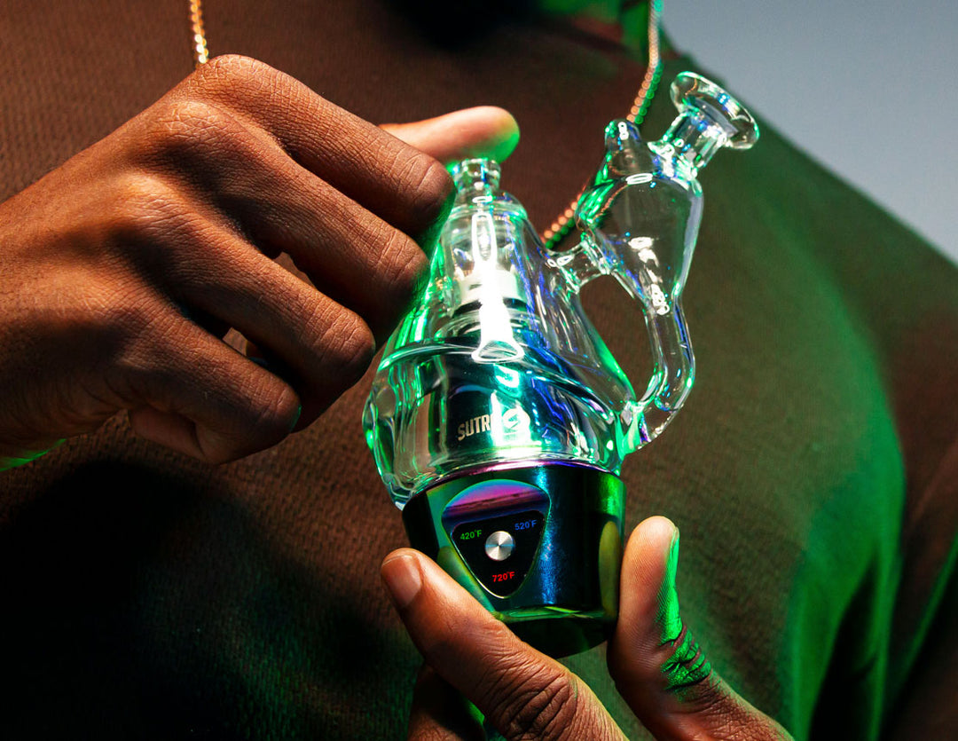 Man holding Sutra DBR Pro in front of gray studio background